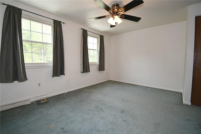 carpeted spare room featuring baseboards and a ceiling fan