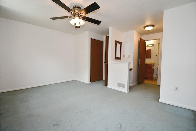 unfurnished bedroom featuring visible vents, carpet flooring, baseboards, and connected bathroom