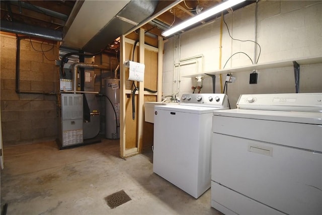 laundry room with laundry area, a sink, washer and clothes dryer, and gas water heater
