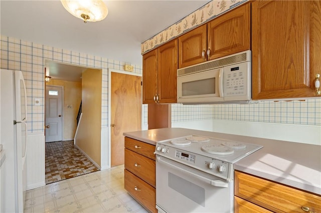 327 Pinehaven Dr, Upper St Clair, PA 15241 - kitchen featuring white appliances, light countertops, brown cabinetry, decorative backsplash, and light floors