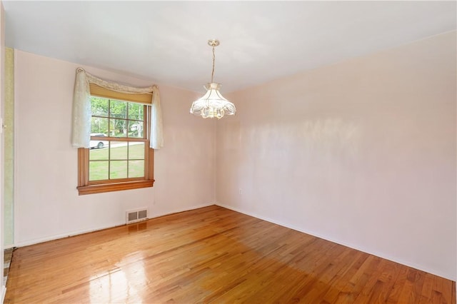327 Pinehaven Dr, Upper St Clair, PA 15241 - spare room with visible vents, baseboards, wood finished floors, and an inviting chandelier