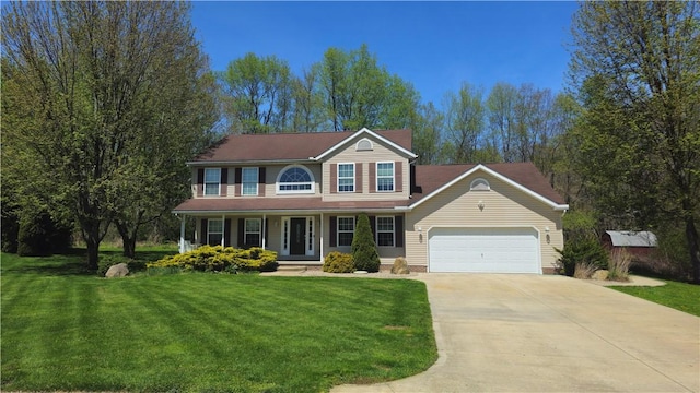 traditional-style home with an attached garage, a front lawn, covered porch, and concrete driveway