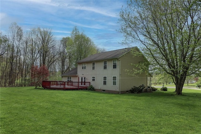 back of property featuring a lawn, crawl space, and a deck