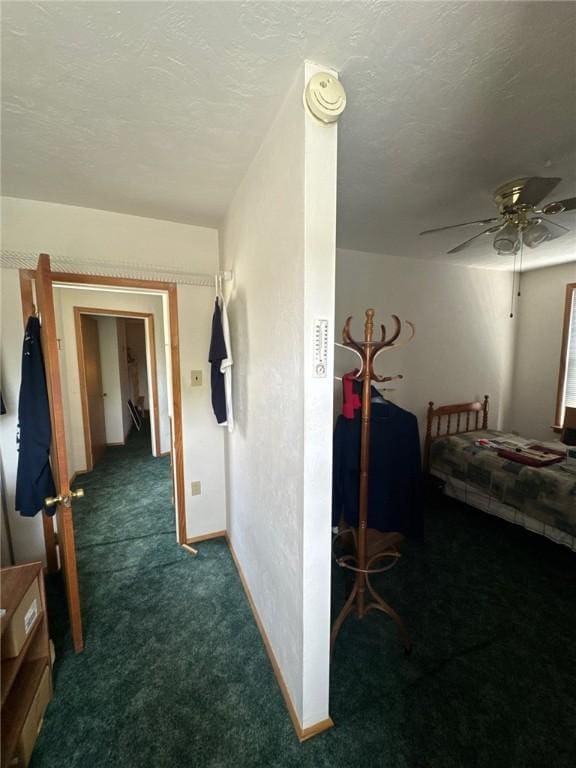 hallway featuring carpet floors and a textured ceiling