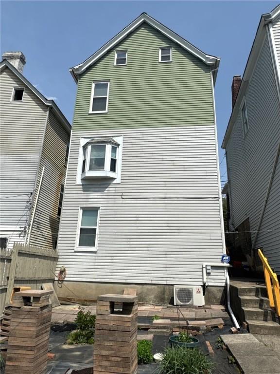 rear view of house with fence and ac unit