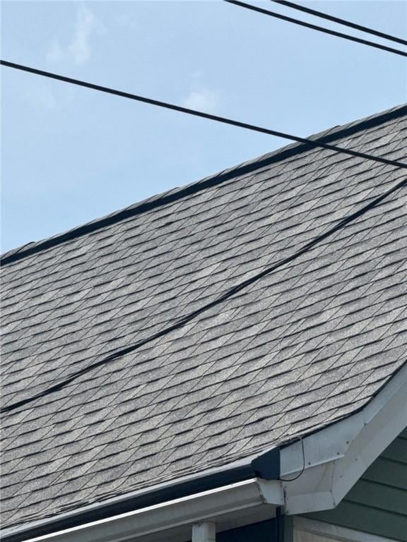 exterior details with roof with shingles