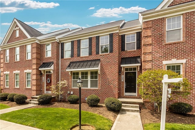 townhome / multi-family property featuring brick siding