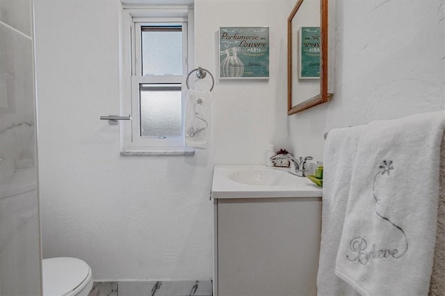 bathroom featuring vanity, marble finish floor, and toilet