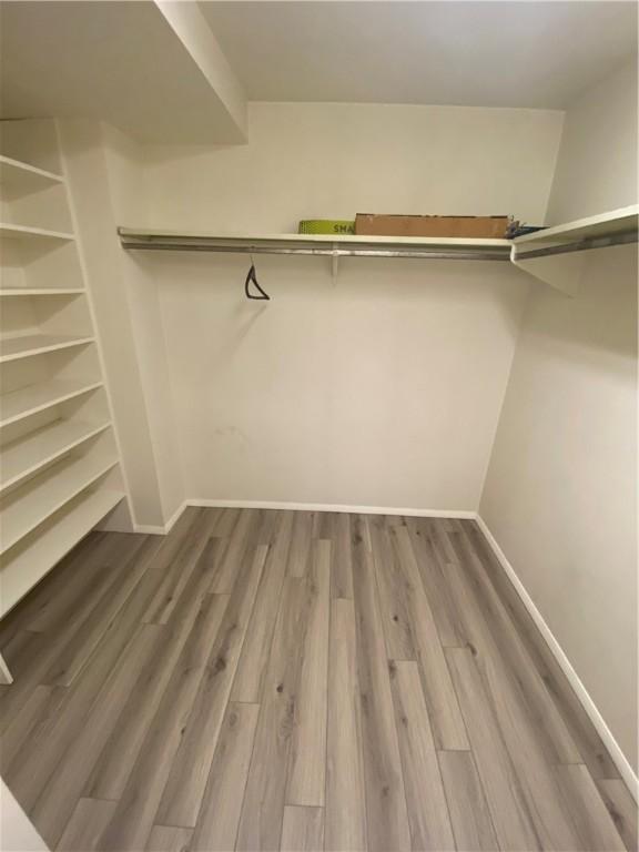 spacious closet with wood finished floors