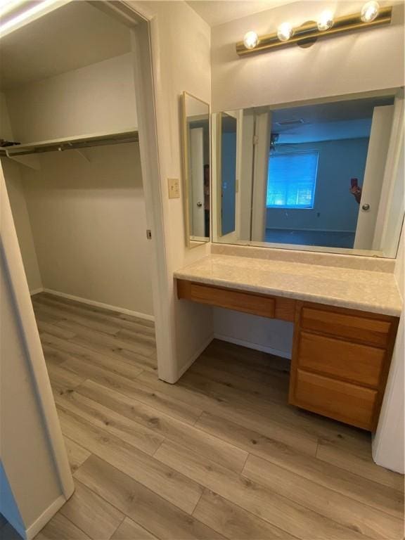 bathroom featuring vanity and wood finished floors