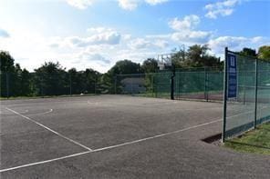 view of tennis court with fence