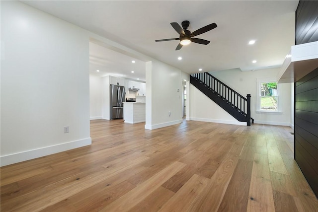 1203 Berkshire Ave, Brookline, PA 15226 - unfurnished living room with baseboards, ceiling fan, light wood-style flooring, and stairway