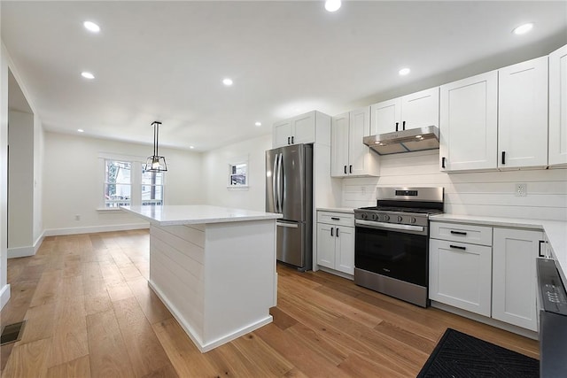 1203 Berkshire Ave, Brookline, PA 15226 - kitchen featuring under cabinet range hood, stainless steel appliances, a kitchen island, and light wood-style floors