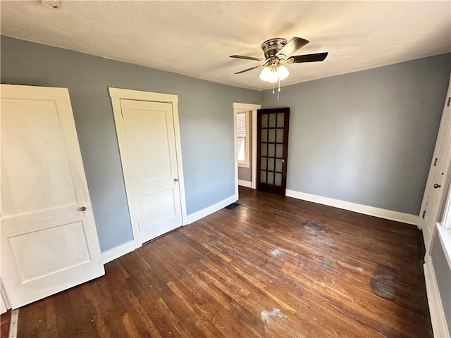 unfurnished bedroom featuring baseboards, ceiling fan, and wood finished floors