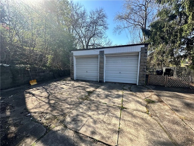detached garage featuring fence