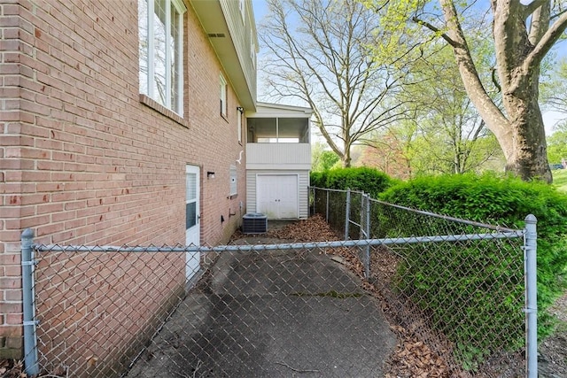 view of property exterior with fence and brick siding