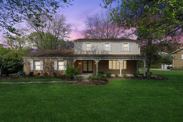 view of front facade with a yard and a porch