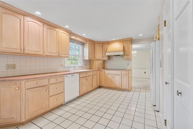 kitchen featuring light brown cabinets, white appliances, light countertops, premium range hood, and light tile patterned floors