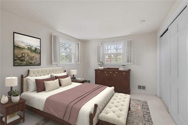 bedroom featuring multiple windows, light carpet, a closet, and visible vents