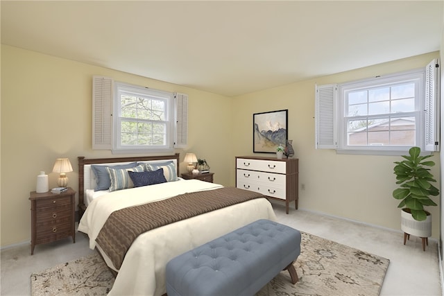 bedroom featuring baseboards, light colored carpet, and multiple windows