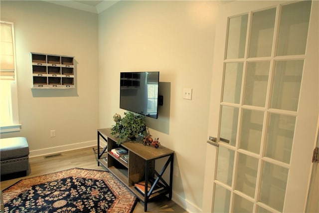 living room featuring baseboards, wood finished floors, and visible vents