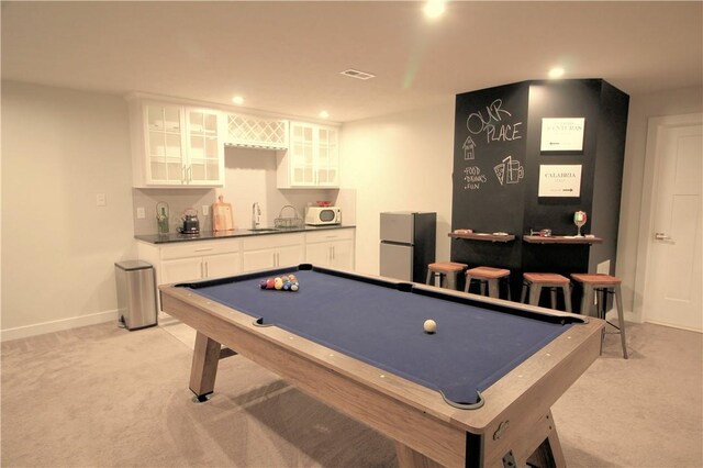 rec room featuring indoor wet bar, pool table, light colored carpet, and a sink