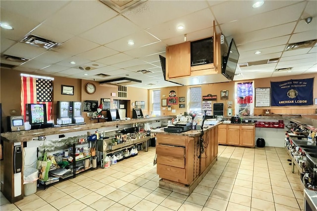 400 Duss Ave, Ambridge, PA 15003 - kitchen with a kitchen island, light tile patterned flooring, visible vents, and a drop ceiling