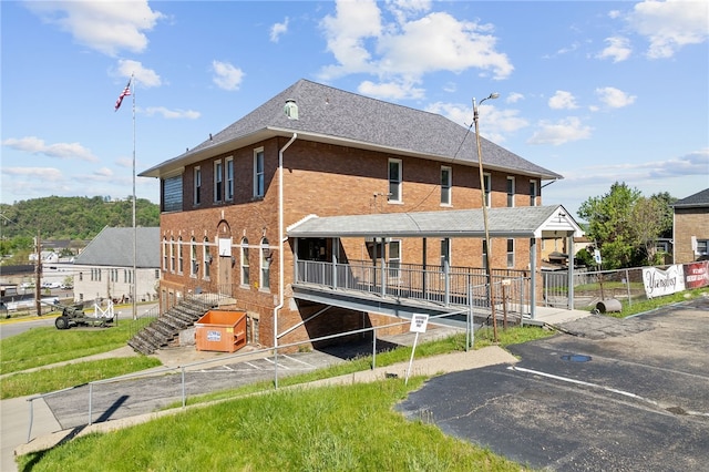 400 Duss Ave, Ambridge, PA 15003 - rear view of property with fence, roof with shingles, uncovered parking, and brick siding