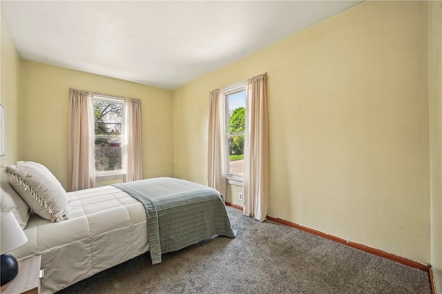 carpeted bedroom featuring baseboards