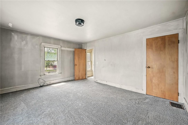 empty room featuring visible vents and carpet