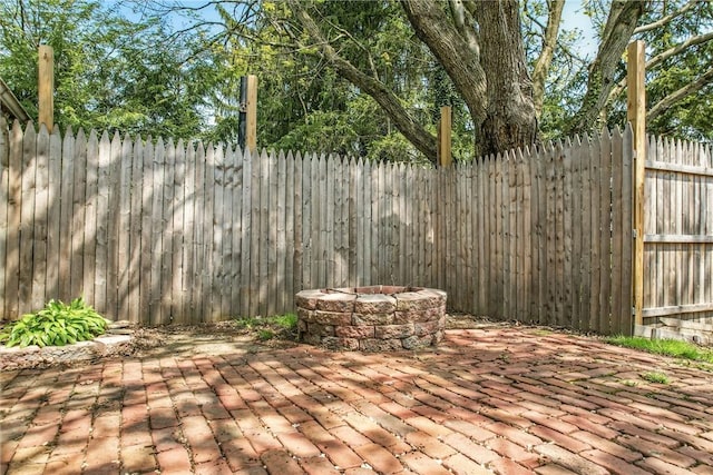 view of patio / terrace with a fire pit and a fenced backyard
