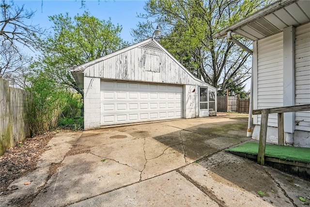 detached garage featuring fence