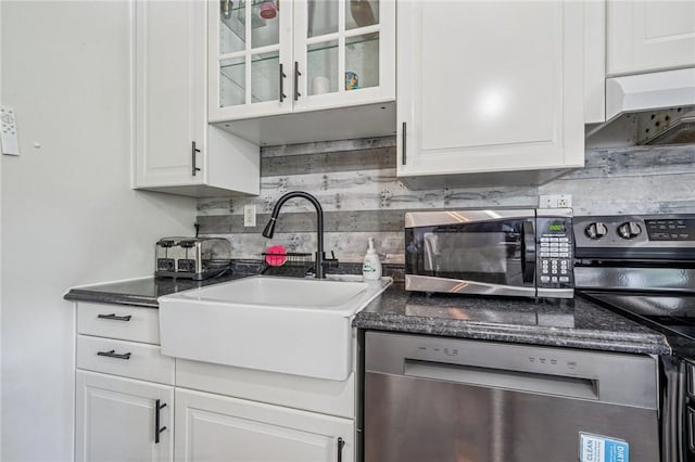 1 Fitch Ln, Mount Pleasant Twp Wml, PA 15601 - kitchen with glass insert cabinets, white cabinetry, tasteful backsplash, a sink, and appliances with stainless steel finishes