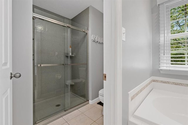 full bathroom featuring toilet, tile patterned floors, a garden tub, and a stall shower