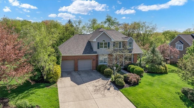 view of front of home featuring brick siding, a garage, a front lawn, and concrete driveway