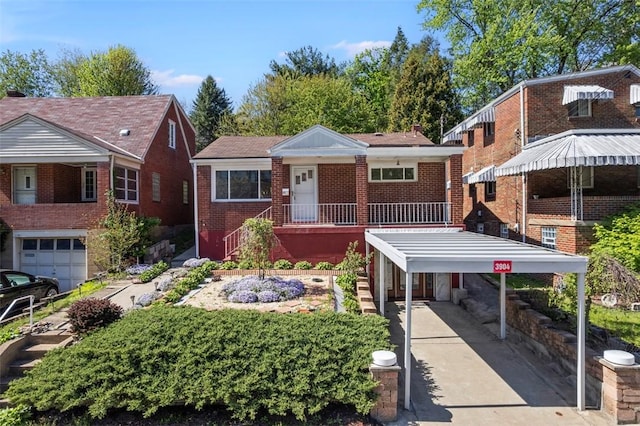 view of front of house with brick siding, concrete driveway, and a carport