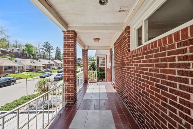 balcony with covered porch and a residential view