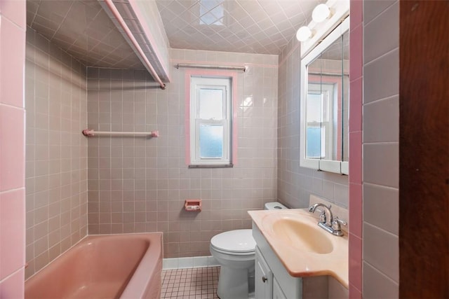 bathroom featuring tile walls, tile patterned flooring, and a wealth of natural light