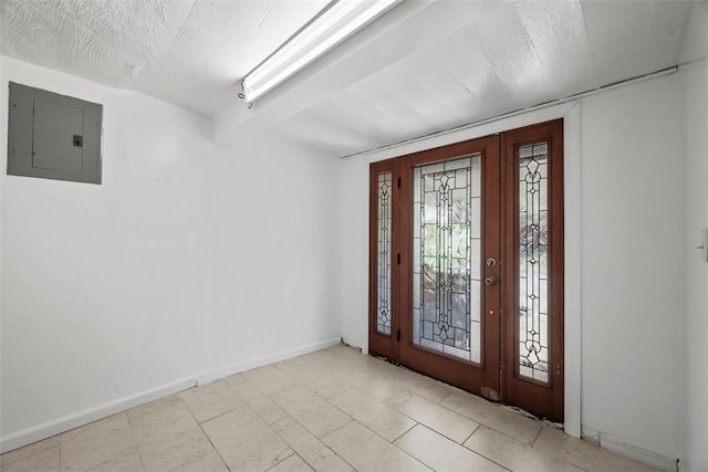 entryway with baseboards, electric panel, and a textured ceiling