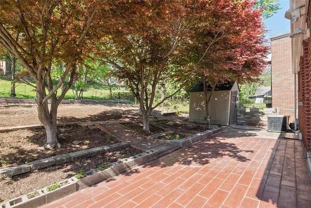 view of patio featuring an outdoor structure, central AC unit, and a shed