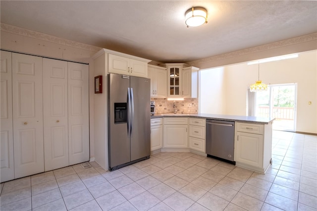 1437 Yorktown Dr, Cecil, PA 15055 - kitchen with a peninsula, light tile patterned floors, tasteful backsplash, and stainless steel appliances