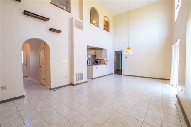 1437 Yorktown Dr, Cecil, PA 15055 - unfurnished living room featuring visible vents and a towering ceiling