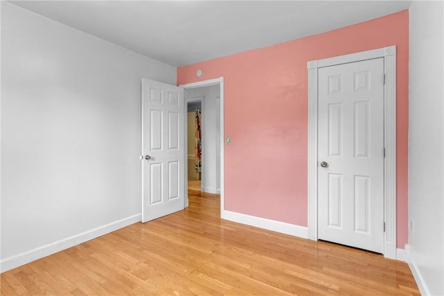 unfurnished bedroom with light wood-style floors and baseboards