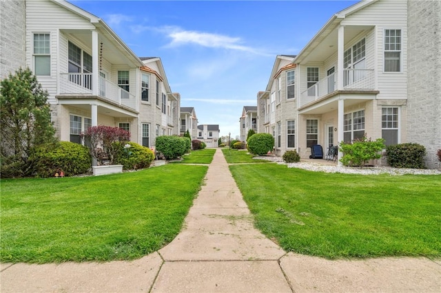 view of community featuring a lawn and a residential view
