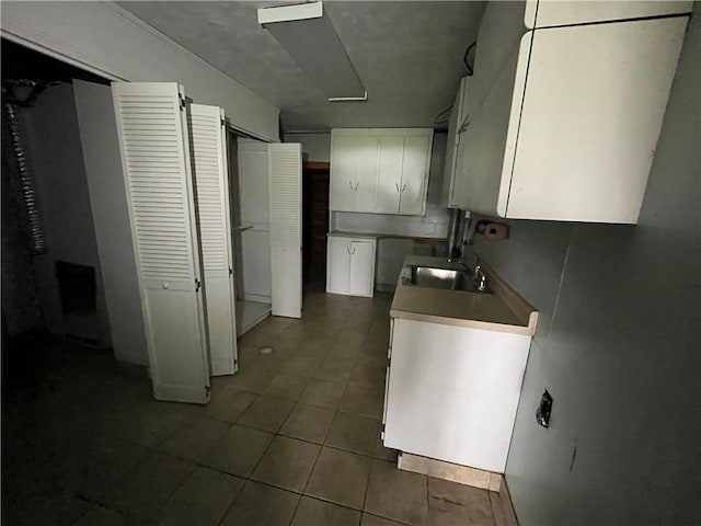 246 Anderson Ave, Indiana Boro Ind, PA 15701 - kitchen with a sink, light countertops, white cabinets, and dark tile patterned flooring