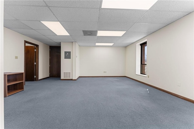 empty room featuring baseboards, visible vents, and a drop ceiling