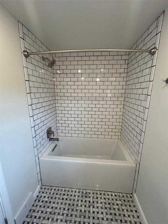 full bathroom featuring baseboards, tile patterned floors, and bathing tub / shower combination