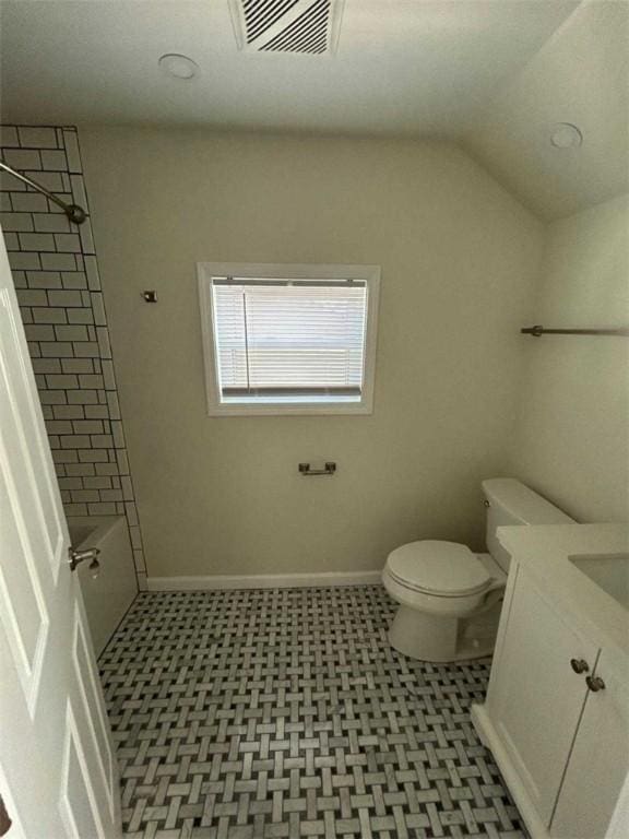 bathroom with visible vents, vanity, toilet,  shower combination, and vaulted ceiling
