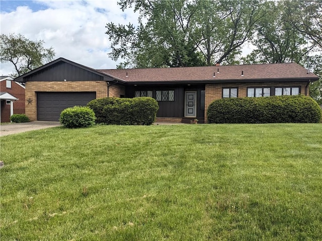 211 Wainwright Dr, Mckeesport, PA 15132 - ranch-style home with brick siding, driveway, a front yard, and a garage