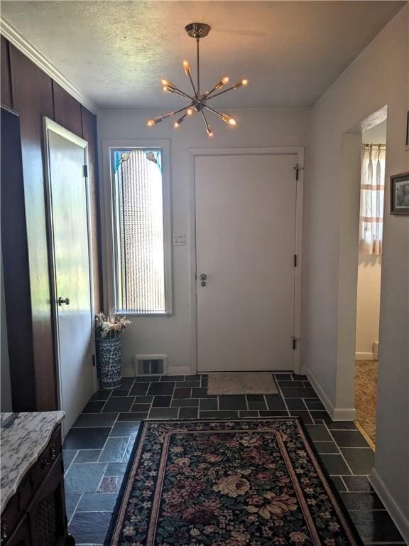 211 Wainwright Dr, Mckeesport, PA 15132 - entryway featuring visible vents, stone finish flooring, baseboards, and a chandelier